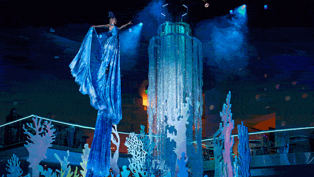 A performer in a glowing costume at Glow Nights at Georgia Aquarium