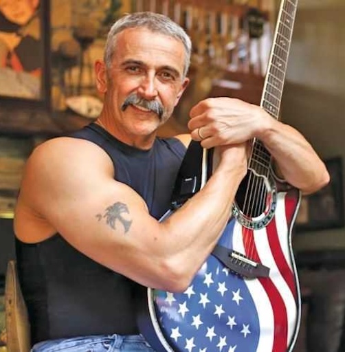 Musician performs with acoustic guitar at the Foothills Festival in Albany, Kentucky.