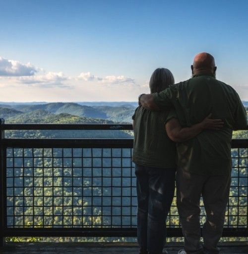 Couple overlooking mountain landscape from scenic overlook in Harlan County