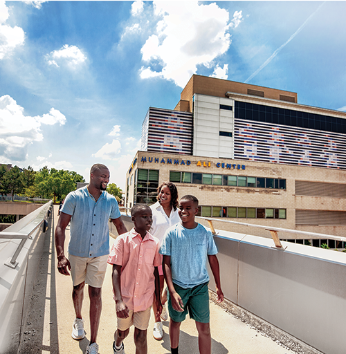 Family walking in front of the Muhammad Ali Center