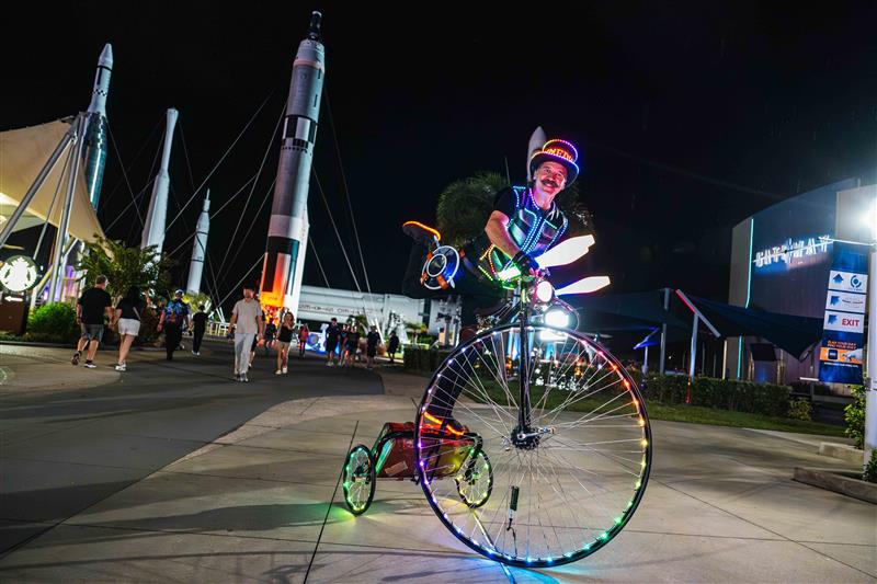 a man riding a bicycle with lights