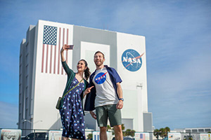 a man and woman taking a selfie in front of a building