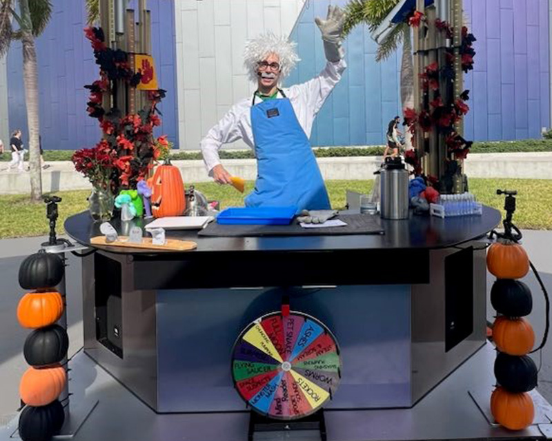 a man wearing a wig and standing at a counter