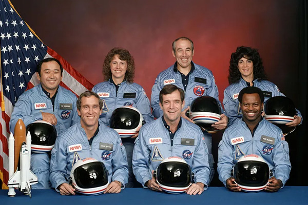 a group of people standing in front of a sign