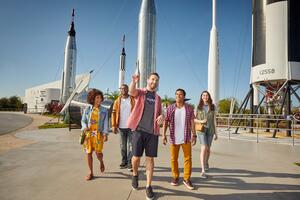 a group of people walking in front of rockets