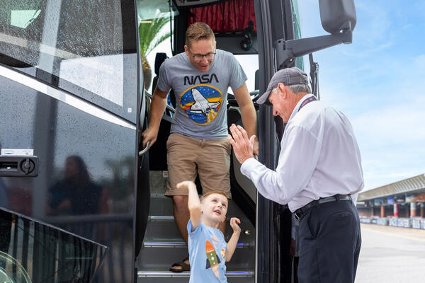 a man and a child getting off a bus