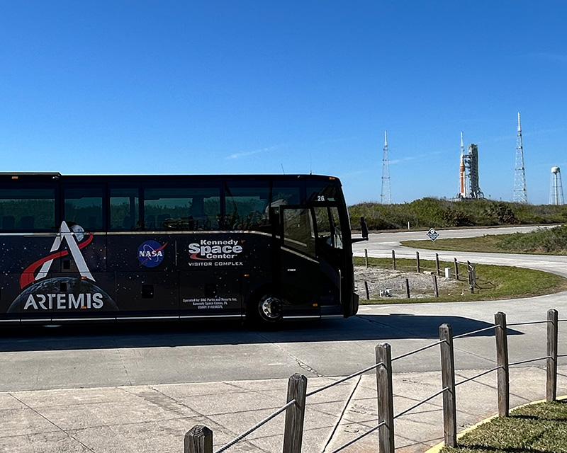 a black bus on a road