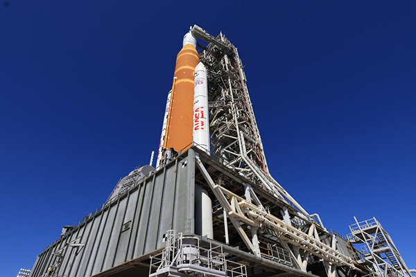 a rocket on a launch pad with Hallgrímskirkja in the background
