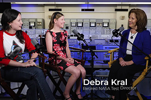 a group of people sitting in chairs with microphones