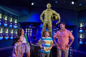 a group of people standing around a statue