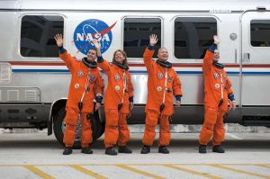 a group of people in orange suits waving