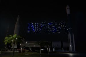 a rocket and a building at night