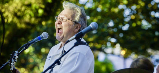 A male musician sings live music.