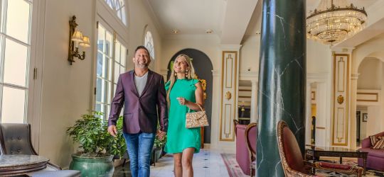 A man and woman walk together at the Bourbon Orleans Hotel in New Orleans.