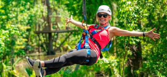 A woman zip lines in Louisiana's River Parishes.