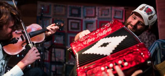 Two male musicians play the fiddle and accordion in Lafayette, Louisiana.