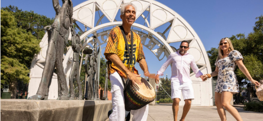 A man plays a conga drum in front of Armstrong Park in New Orleans.