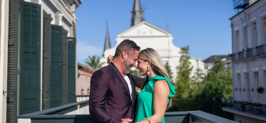 A couple embraces in front of the historic St. Louis Cathedral in New Orleans.
