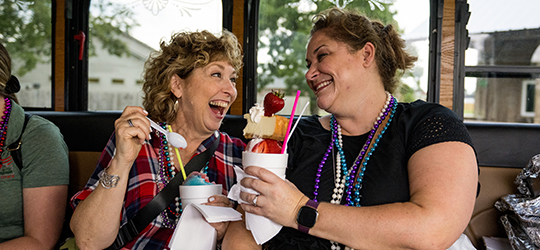 Two travelers enjoy a snoball.