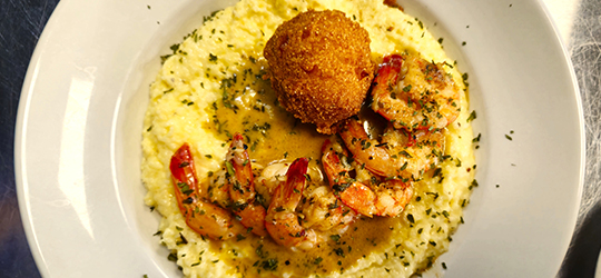 A plate of shrimp and grits.