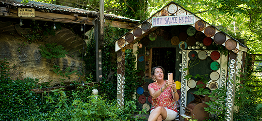 A traveler explore the Abita Mystery House.