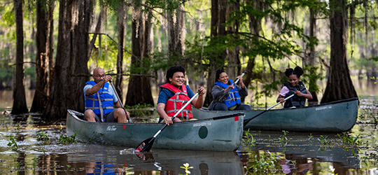 A family kayaks together.