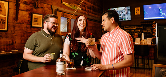 A group samples beverages at Terrebonne Distillers.