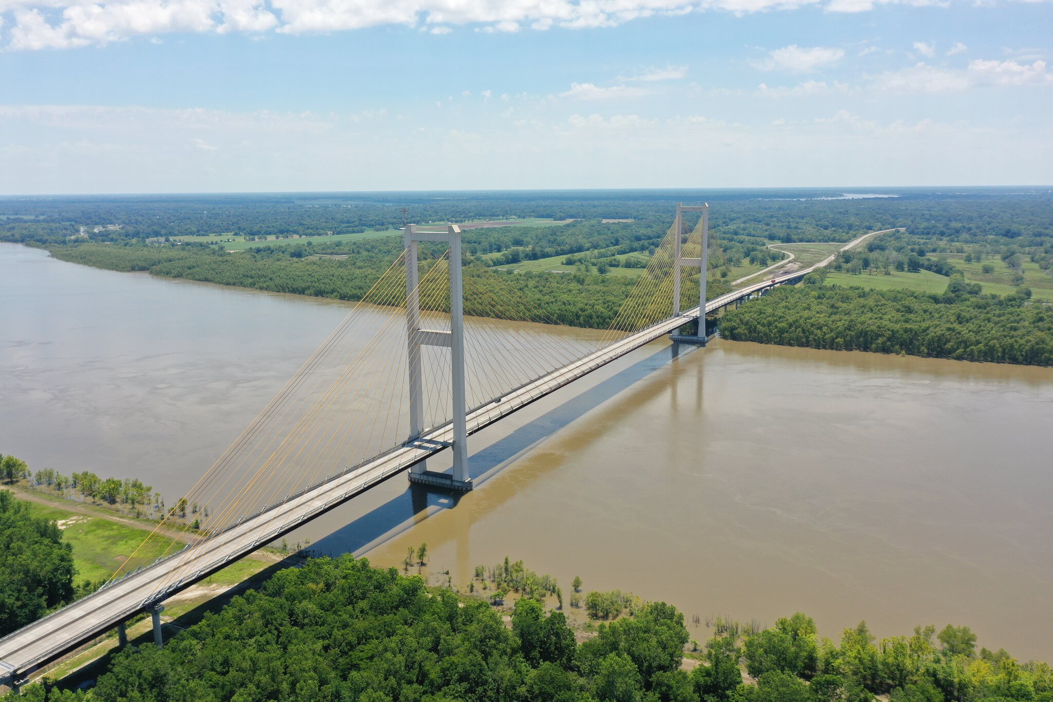 The John James Audubon Bridge, a suspension bridge stretching across a wide river with forests on either side.