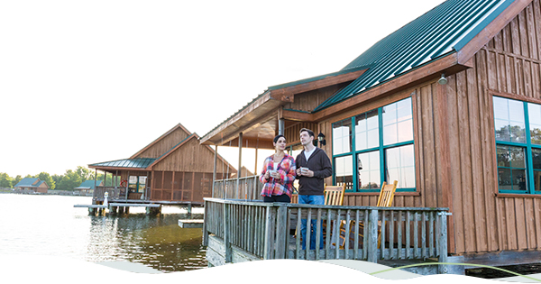 Two people sip coffee while looking at the Poverty Point Reservoir.