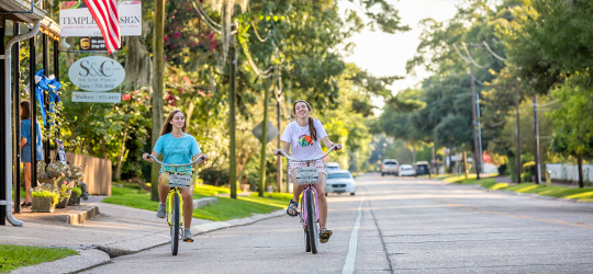 People bike through St. Francisville.