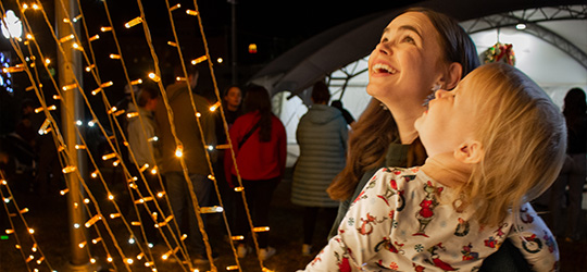 Woman and child gaze at holiday lights in Ruston, LA
