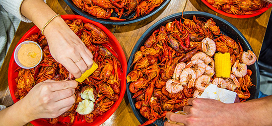 People peeling crawfish.