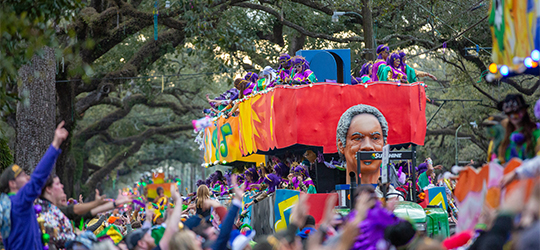 A Mardi Gras float rolls down a street