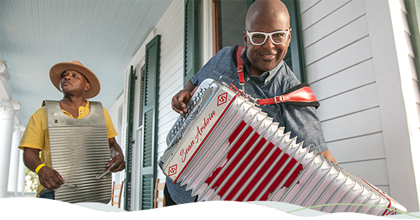 Two musicians perform traditional Zydeco music.