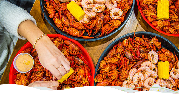 Patrons sample crawfish at a crawfish boil.