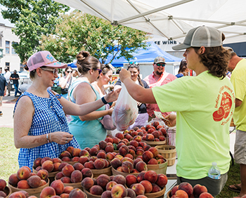 Festival attendees buy fresh peaches at the Louisiana Peach Festival.