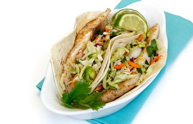 Amberjack tacos stuffed with fresh slaw.