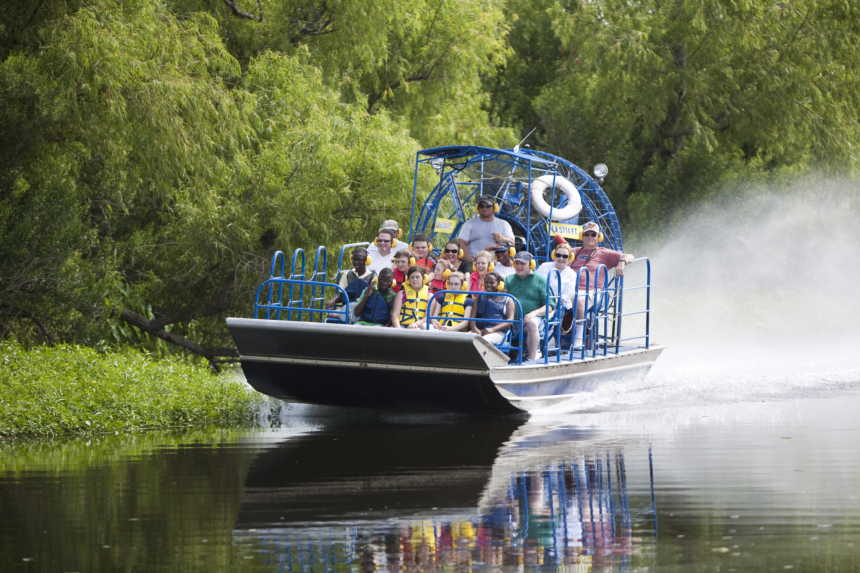 Visitors ride an airboat through Louisiana's River Parishes.