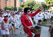 A festival attendee dresses as Elvis.