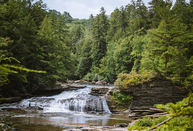 Picture of people enjoying a beautiful waterfall.