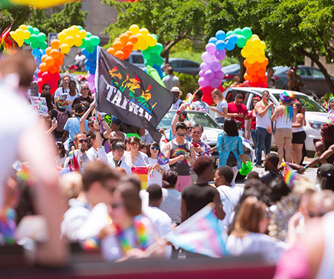Picture of a crowd of people enjoying a Pride festival.