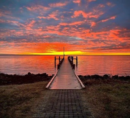 Sunset overlooking a boardwalk.