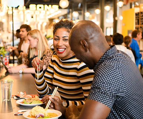 Picture of a couple enjoying their Asian Cuisine.