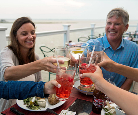 Picture of a group of people enjoying Maryland's Great Seafood and some Cocktails.