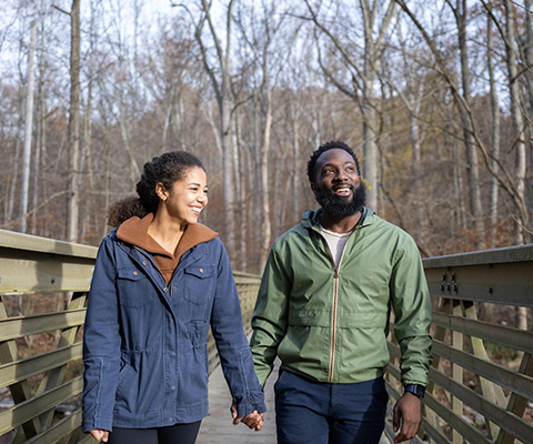 Picture of a couple holding hands and enjoying a walk together.