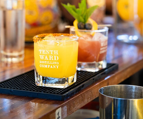 A picture of two glasses filled with cocktails from Tenth Ward Distilling.