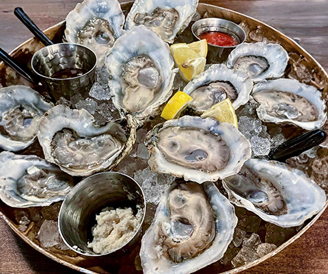 Picture of a platter of shucked oysters on the half-shell.