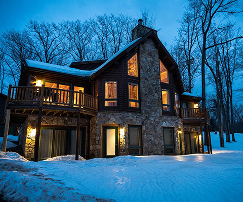 Picture of a beautiful, cozy lodge surrounded by snow.