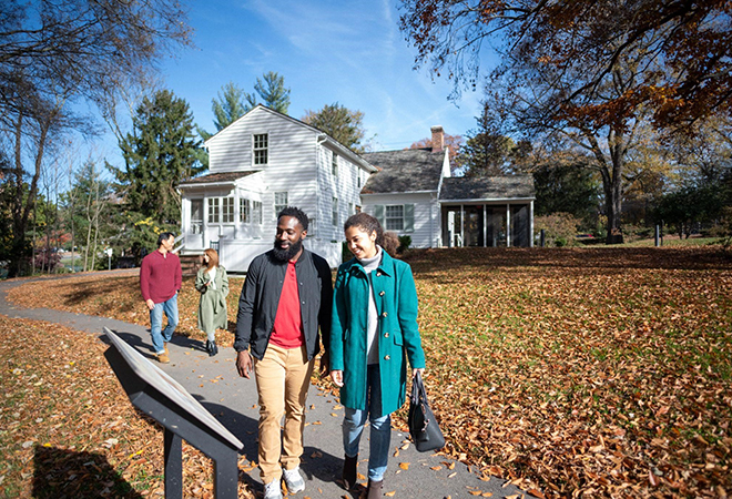Picture of two couples walking along a path in the Fall.