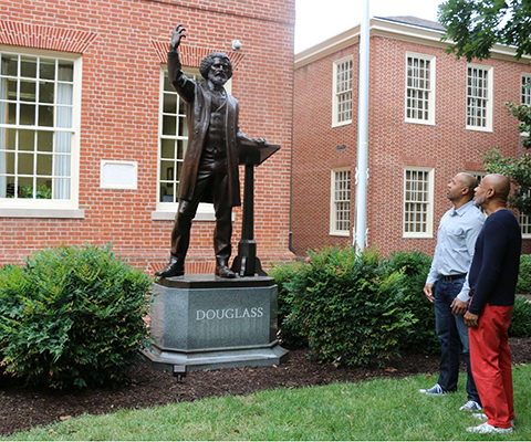 Two men admire the statue of Frederick Douglass in Easton.